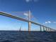 Majestic view of a bridge and sailboat on open waters under a bright blue sky at 2908 Fiddlers Bnd, Palmetto, FL 34221