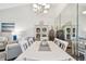 Dining area with contemporary furniture, a decorative chandelier, and a large mirror for a spacious feel at 2908 Fiddlers Bnd, Palmetto, FL 34221
