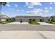 Charming villa with lush landscaping, well-manicured lawns, and a double driveway leading to attached garages at 2908 Fiddlers Bnd, Palmetto, FL 34221