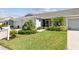 This home features vibrant landscaping, lush green lawns, and meticulous shrubbery surrounding the front of the property at 2908 Fiddlers Bnd, Palmetto, FL 34221