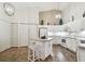 Bright kitchen featuring an island, white cabinets, modern appliances, and ample storage space at 2908 Fiddlers Bnd, Palmetto, FL 34221