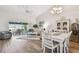 Bright open-concept with wood floors, contemporary furniture, and a view of the lake from the sliding glass doors at 2908 Fiddlers Bnd, Palmetto, FL 34221