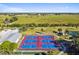 Aerial view of pickleball courts surrounded by lush green fields, offering an active lifestyle in a scenic setting at 2908 Fiddlers Bnd, Palmetto, FL 34221