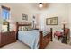 Bedroom with a wood bed, carpeted floors, and windows allowing natural light at 3100 Sheboygan Ave, North Port, FL 34286