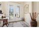 Bright foyer featuring decorative glass doors, accent furnishings, and tile flooring creating a stylish entrance at 3100 Sheboygan Ave, North Port, FL 34286