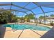 Sparkling screened pool with beautiful landscaping and lion statue at 3100 Sheboygan Ave, North Port, FL 34286