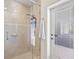 A tile shower features glass door, a hand-held sprayer, and a shower caddy at 3100 Sheboygan Ave, North Port, FL 34286