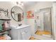 Bright bathroom featuring a modern vanity, stylish mirror, and walk-in shower at 3289 Fairhaven Ln # 112, Sarasota, FL 34239