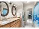 Bathroom featuring double sinks, granite countertops and decorative mirrors, next to toilet and mirrored closet door at 3289 Fairhaven Ln # 112, Sarasota, FL 34239