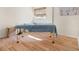 Bedroom with hardwood floors, natural light, and a massage table set up at 3289 Fairhaven Ln # 112, Sarasota, FL 34239