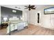 Bedroom with wood floors, a dark accent wall, and a view of an open closet at 3289 Fairhaven Ln # 112, Sarasota, FL 34239