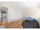 Bedroom with hardwood floors and view to hallway and closet at 3289 Fairhaven Ln # 112, Sarasota, FL 34239