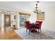Dining room with modern chandelier, dark wood table, and lots of natural light at 3289 Fairhaven Ln # 112, Sarasota, FL 34239