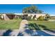 Charming single-story home featuring lush green lawn and mature landscaping at 3289 Fairhaven Ln # 112, Sarasota, FL 34239