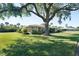 Well-manicured lawn and lush landscaping frame this charming single-story home at 3289 Fairhaven Ln # 112, Sarasota, FL 34239