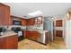 Well-lit kitchen featuring custom wood cabinets, stainless steel appliances, and granite countertops at 3289 Fairhaven Ln # 112, Sarasota, FL 34239