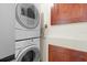 Convenient laundry area with stacked washer and dryer, and storage cabinets at 3289 Fairhaven Ln # 112, Sarasota, FL 34239