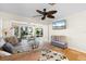 Living room with comfortable seating, ceiling fan and an exit to the outdoor living space at 3289 Fairhaven Ln # 112, Sarasota, FL 34239