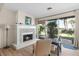 Cozy living room with a decorative fireplace, wood floors, and access to outdoor patio at 3289 Fairhaven Ln # 112, Sarasota, FL 34239