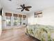 Light and airy main bedroom boasts wood-look flooring, a ceiling fan, and private access to an outdoor area at 3289 Fairhaven Ln # 112, Sarasota, FL 34239