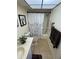 Bright bathroom featuring tiled floors, a shower with grab bar, and a vanity with good lighting at 3500 El Conquistador Pkwy # 357, Bradenton, FL 34210