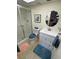 Bright bathroom featuring tiled floors, glass enclosed shower, and a vanity with an interesting mirror at 3500 El Conquistador Pkwy # 357, Bradenton, FL 34210