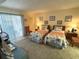 Comfortable bedroom with two twin beds, soft carpet, and sliders to screened patio at 3500 El Conquistador Pkwy # 357, Bradenton, FL 34210