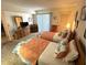 Comfortable bedroom with two twin beds, soft carpet, dresser, and window with natural light at 3500 El Conquistador Pkwy # 357, Bradenton, FL 34210