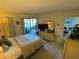 Comfortable bedroom with a queen bed, dresser, and access to a screened-in porch at 3500 El Conquistador Pkwy # 357, Bradenton, FL 34210