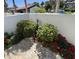 Beautiful courtyard with a brick patio, lush greenery, and vibrant red flowers at 3500 El Conquistador Pkwy # 357, Bradenton, FL 34210