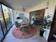 Sunroom with patio doors and wicker furniture overlooking a lush landscape at 3500 El Conquistador Pkwy # 357, Bradenton, FL 34210