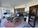 Sunroom with stylish furniture, patio doors, and view into the living area at 3500 El Conquistador Pkwy # 357, Bradenton, FL 34210