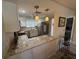 Bright kitchen featuring granite counters, stainless steel appliances, and pendant lighting at 3500 El Conquistador Pkwy # 357, Bradenton, FL 34210