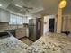 Bright kitchen featuring stainless steel appliances, white cabinets and granite countertops at 3500 El Conquistador Pkwy # 357, Bradenton, FL 34210