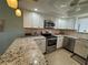 Modern kitchen featuring granite countertops, stainless steel appliances, and ample cabinet space at 3500 El Conquistador Pkwy # 357, Bradenton, FL 34210