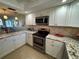 Modern kitchen featuring stainless steel appliances, granite countertops, and open design at 3500 El Conquistador Pkwy # 357, Bradenton, FL 34210