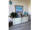 Living room features a white dresser with ocean-themed decor and a seascape painting at 3500 El Conquistador Pkwy # 357, Bradenton, FL 34210