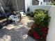 Inviting patio area with brick pavers, chairs, and lush landscaping, creating a serene outdoor space at 3500 El Conquistador Pkwy # 357, Bradenton, FL 34210