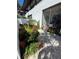 Beautiful patio area with brick pavers, a screened lanai, and vibrant landscaping, ideal for enjoying the outdoors at 3500 El Conquistador Pkwy # 357, Bradenton, FL 34210