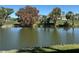 Scenic view of a tranquil pond surrounded by lush greenery and trees, enhancing the property's natural beauty at 3500 El Conquistador Pkwy # 357, Bradenton, FL 34210