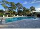 Community pool with lounge chairs and well-maintained landscaping at 3500 El Conquistador Pkwy # 357, Bradenton, FL 34210