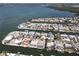 An aerial view of a waterfront community with homes, private docks, and boat access to the bay at 3708 Plumosa Ter, Bradenton, FL 34210