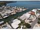 Waterfront home with private dock, screened pool, and lush landscaping on a sunny day at 3708 Plumosa Ter, Bradenton, FL 34210