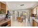 Bright breakfast nook with tiled floors, waterfront view, and a dining set for four at 3708 Plumosa Ter, Bradenton, FL 34210