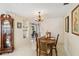 The dining area offers a wooden table set for four, complemented by vintage charm and view into the living space at 3708 Plumosa Ter, Bradenton, FL 34210
