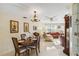 Dining room featuring wood table set for four, blending vintage charm with a view into a cozy living area at 3708 Plumosa Ter, Bradenton, FL 34210