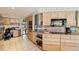 Spacious kitchen features classic light wood cabinetry, modern appliances, ample counter space, and eat-in breakfast area at 3708 Plumosa Ter, Bradenton, FL 34210