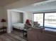 This living room has a pull-down bed, gray laminate flooring and views of the canal at 3708 Plumosa Ter, Bradenton, FL 34210