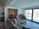 Comfortable living room with gray sectional, murphy bed, and views of the outdoor pool and canal at 3708 Plumosa Ter, Bradenton, FL 34210