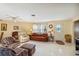 Bright and inviting living room with comfortable seating, a piano and a view of the front entry at 3708 Plumosa Ter, Bradenton, FL 34210